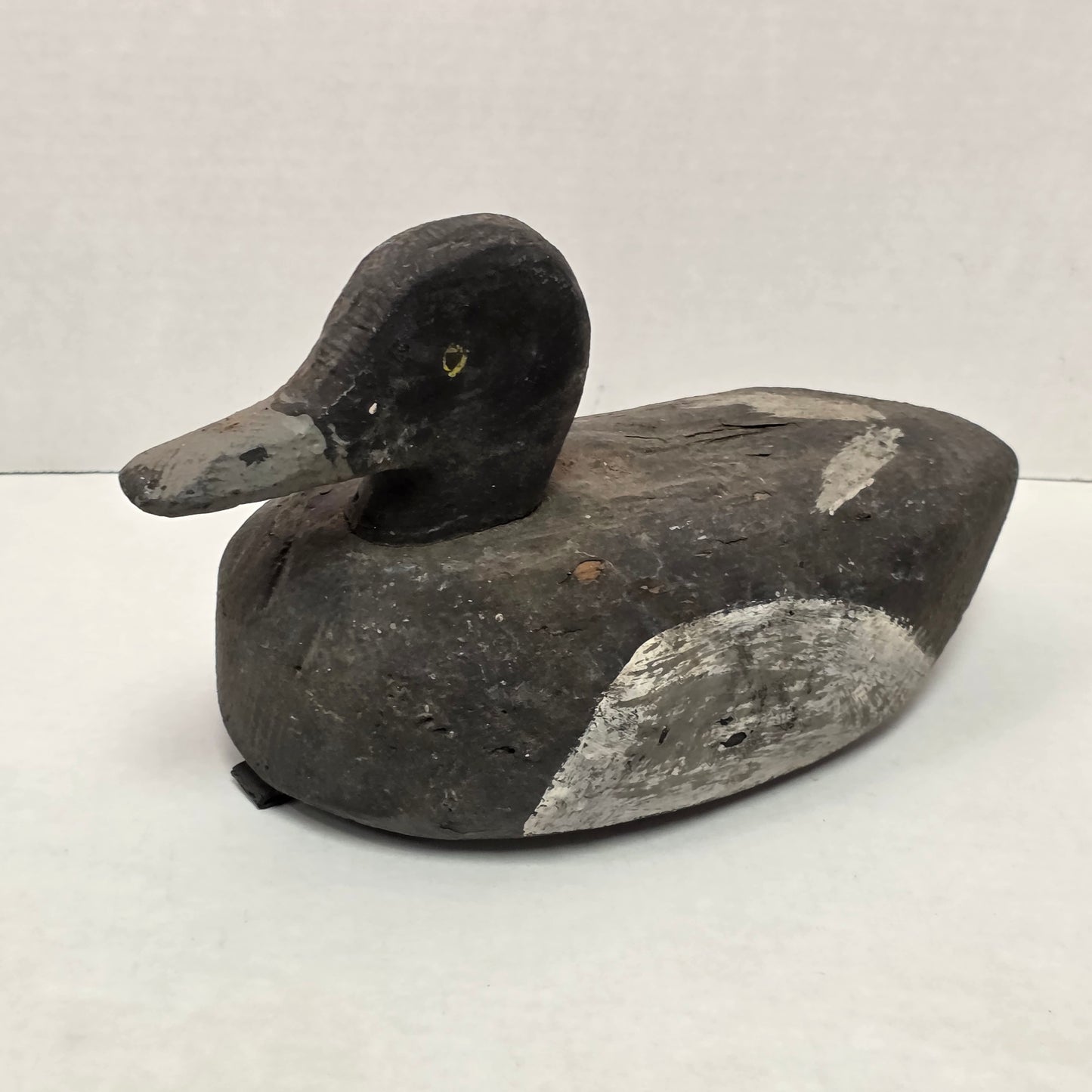 Decorative stone sculpture of a bird on a white background