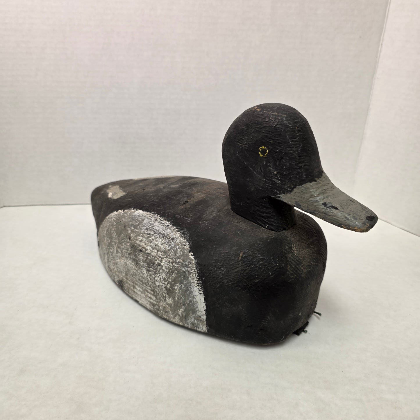 Wooden duck decoy on a white background