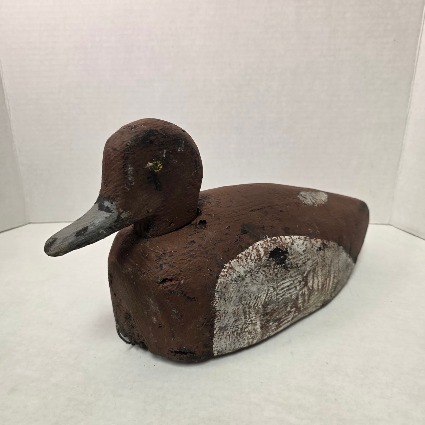Wooden duck decoy on a white background