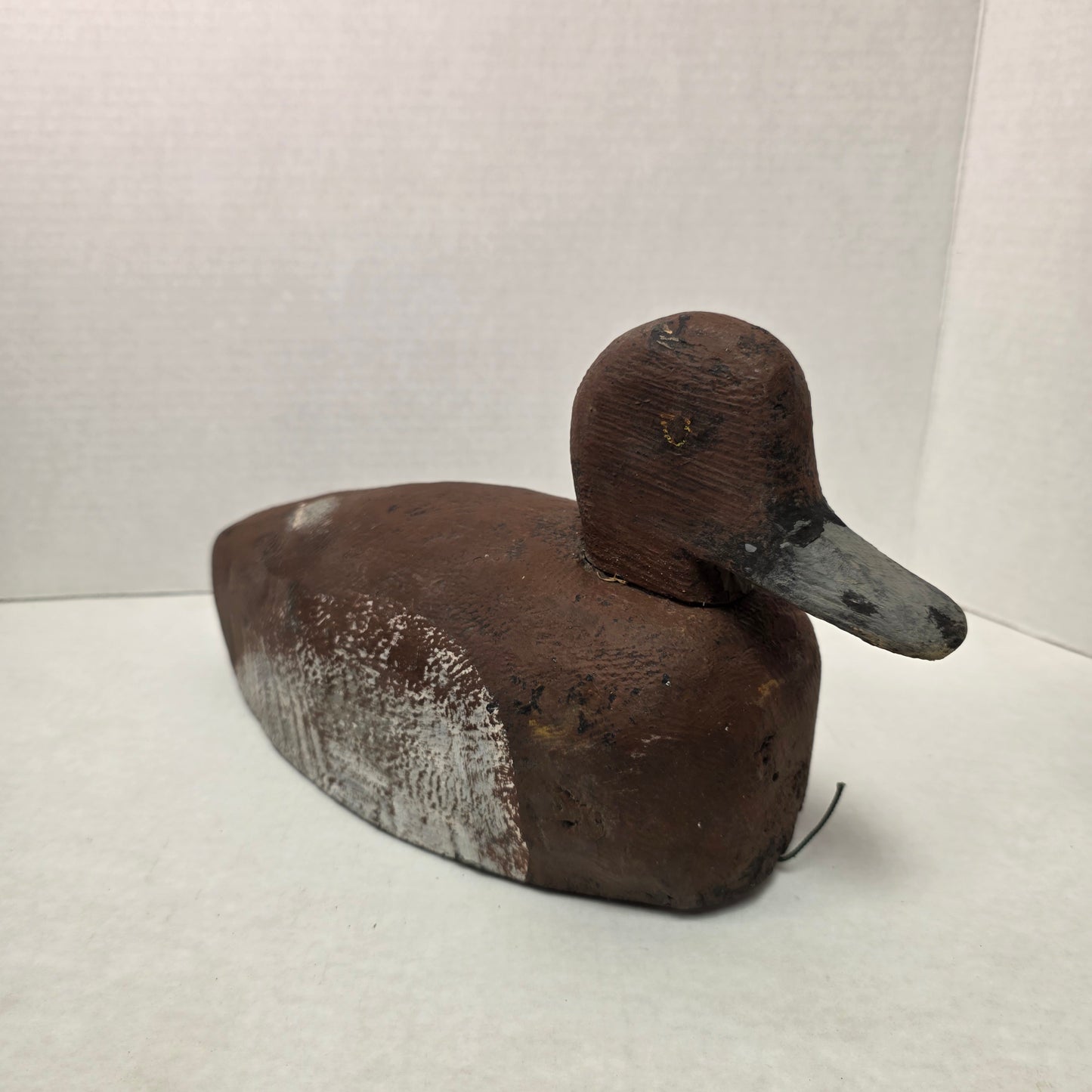 Wooden duck-shaped object on a white background