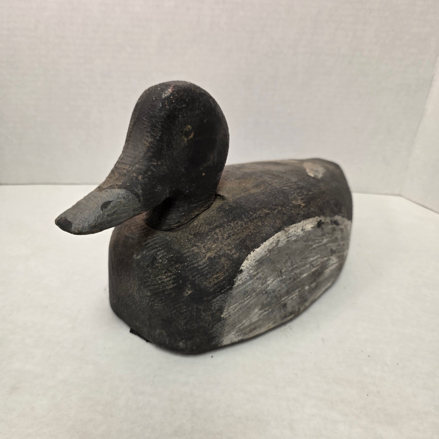 Wooden duck decoy on a white background