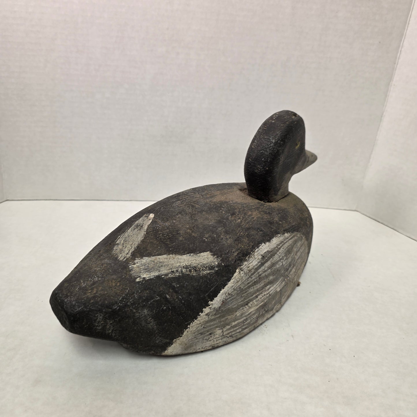 Wooden duck decoy on a white background