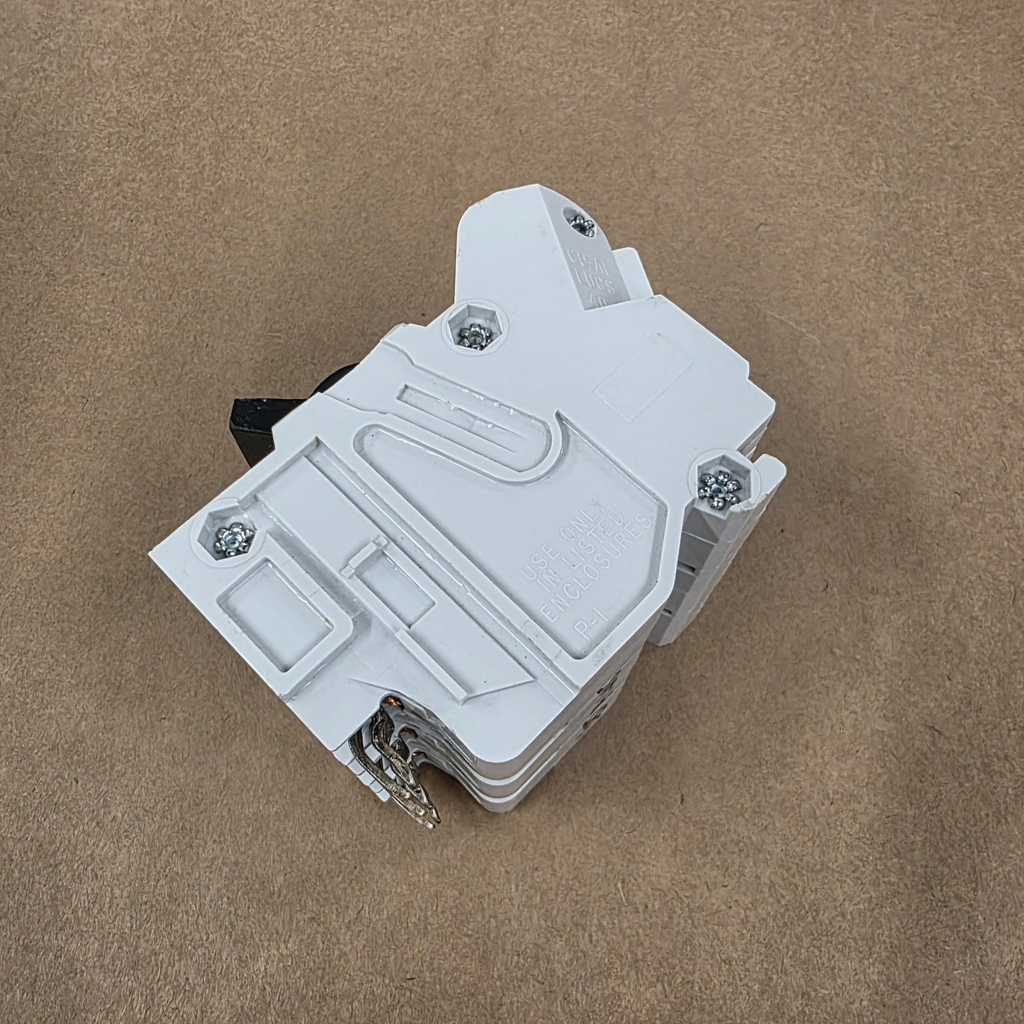 White plastic component on a brown background