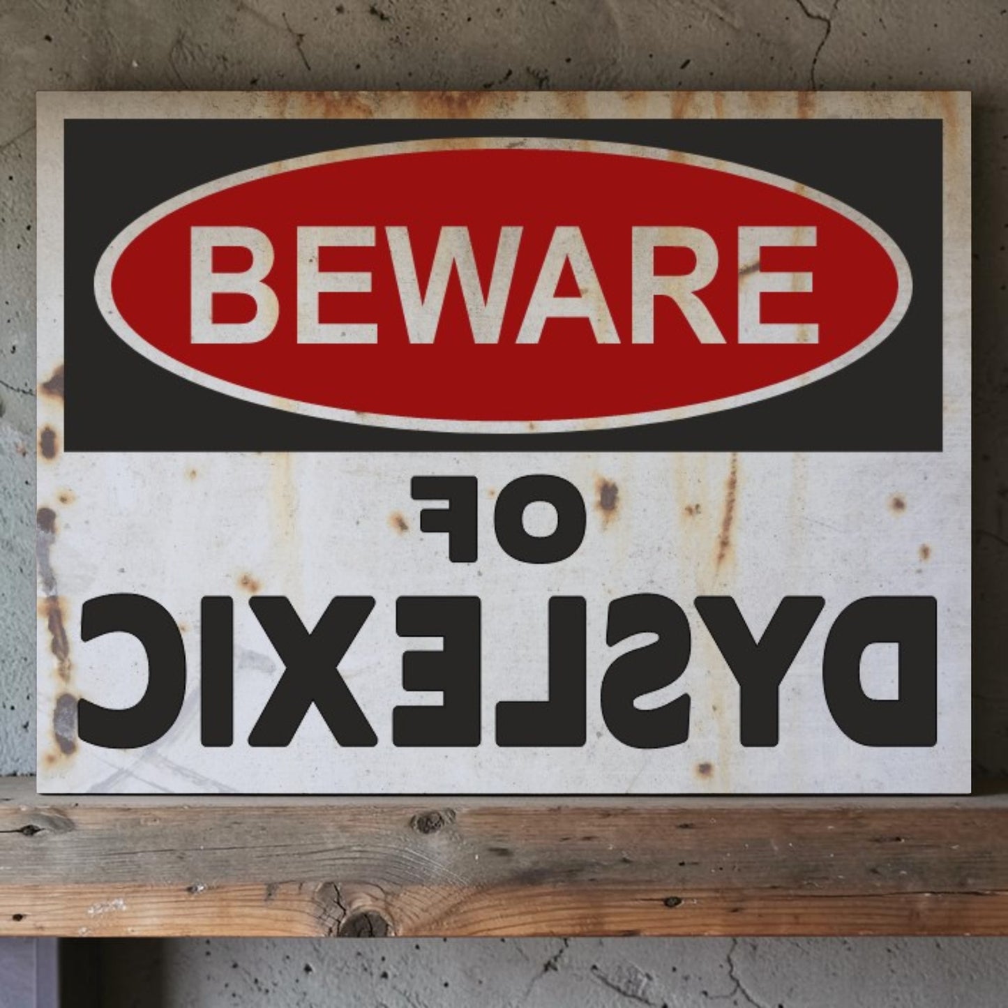 Rustic warning sign with 'Beware of Dyslexic' text on a wooden surface.