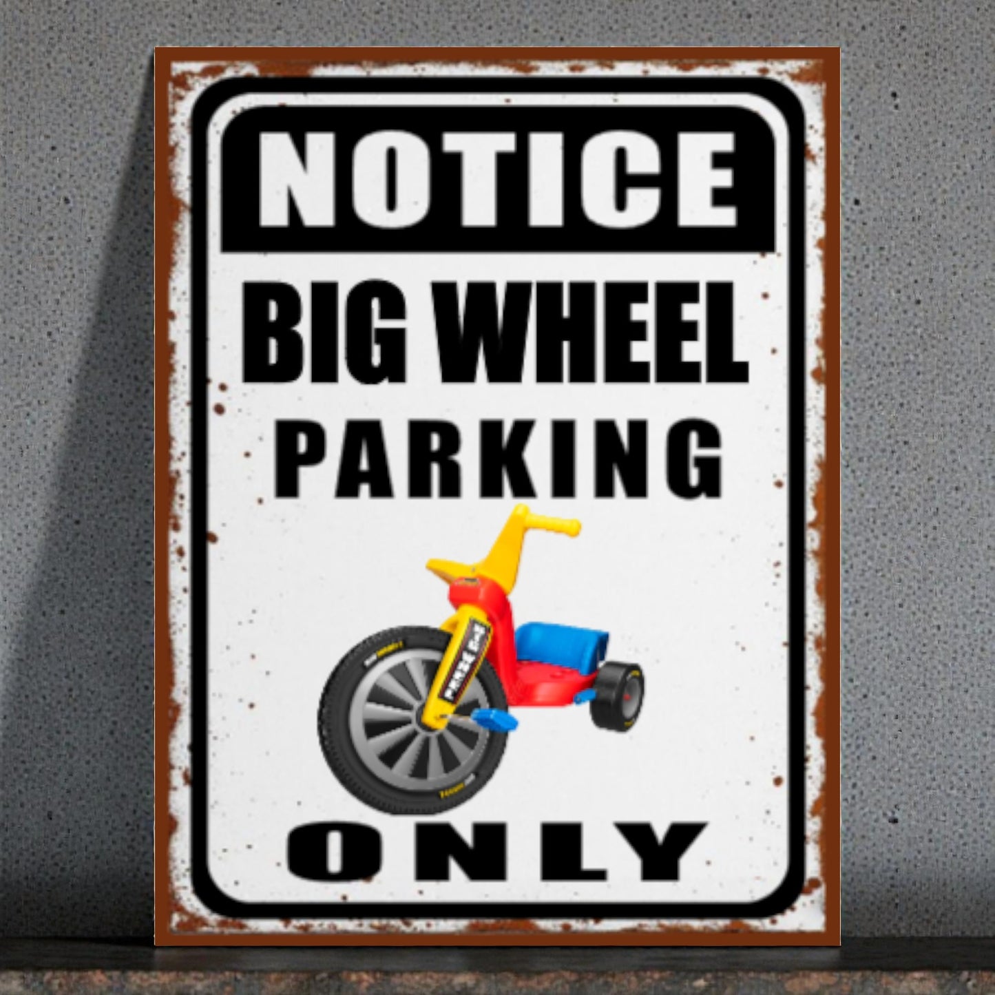 Metal sign with a tricycle graphic and text 'Notice Big Wheel Parking Only' on a gray background