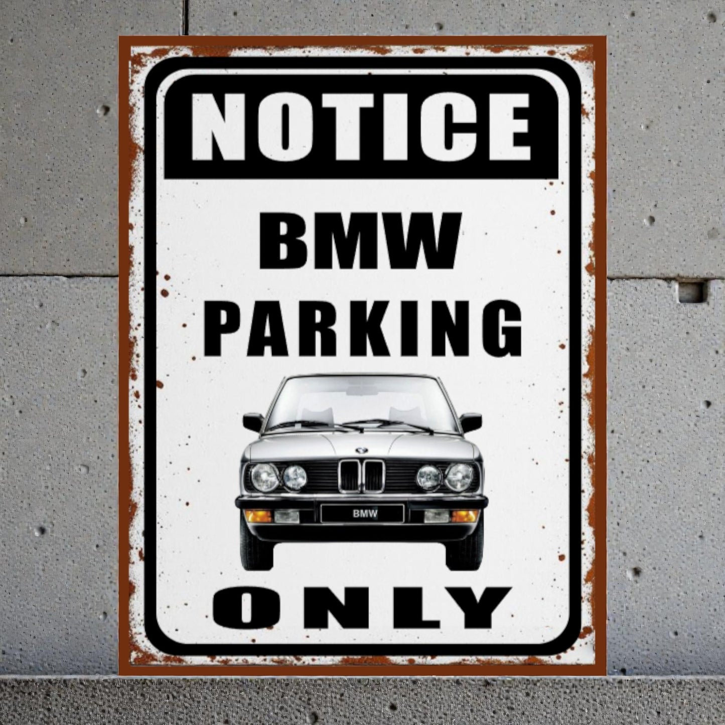 Vintage-style sign with BMW logo on a gray concrete wall