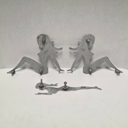 Set of three stainless steel vintage trucker mud flap girl decorations.