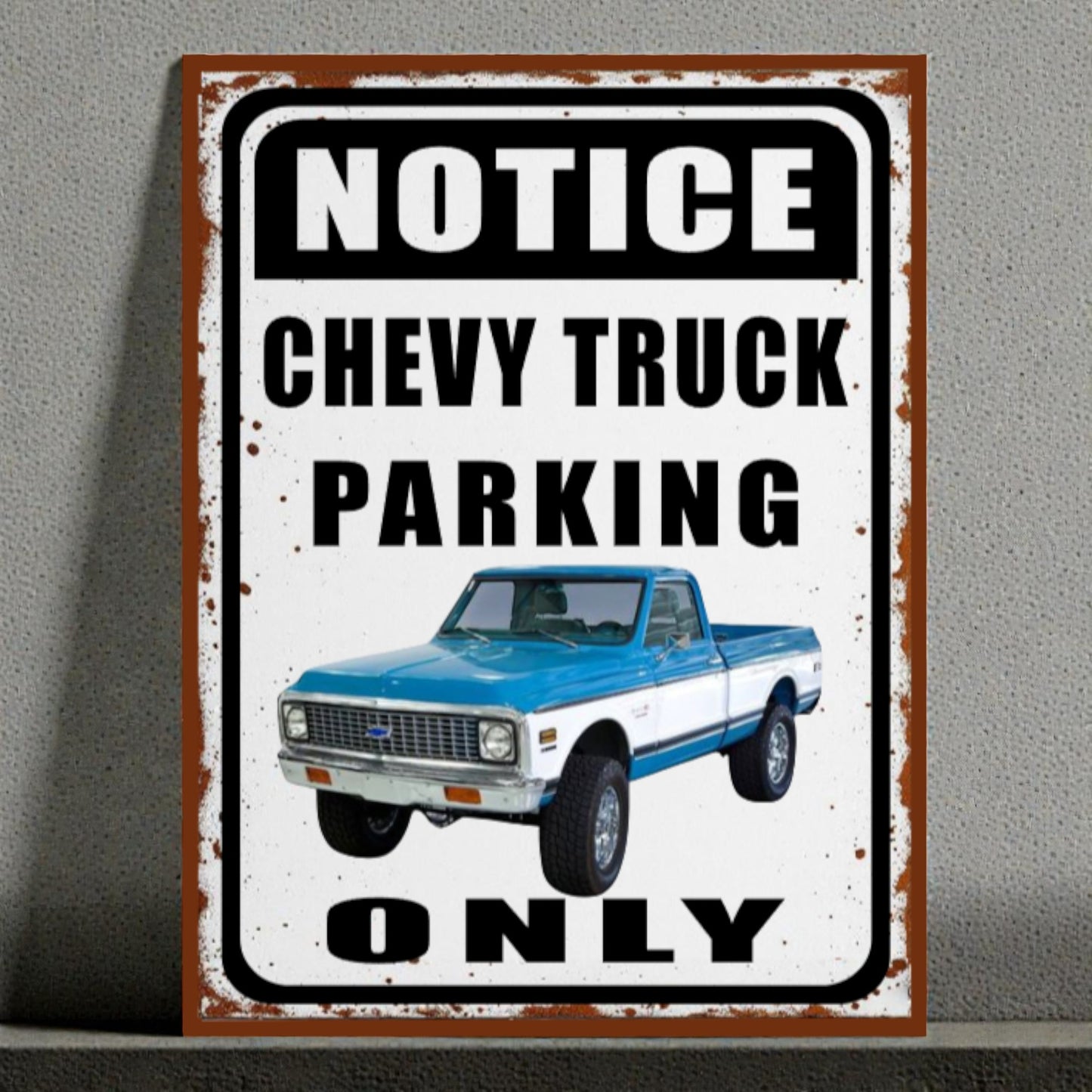 Vintage-style sign with a blue and white Chevy truck and text 'Notice Chevy Truck Parking Only' on a gray background.
