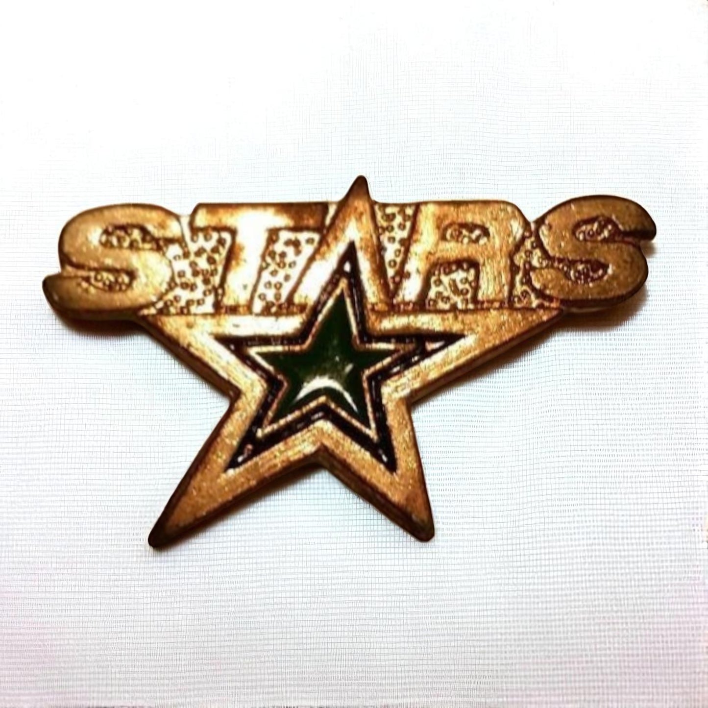 Gold 'STARS' star-shaped badge on a white background