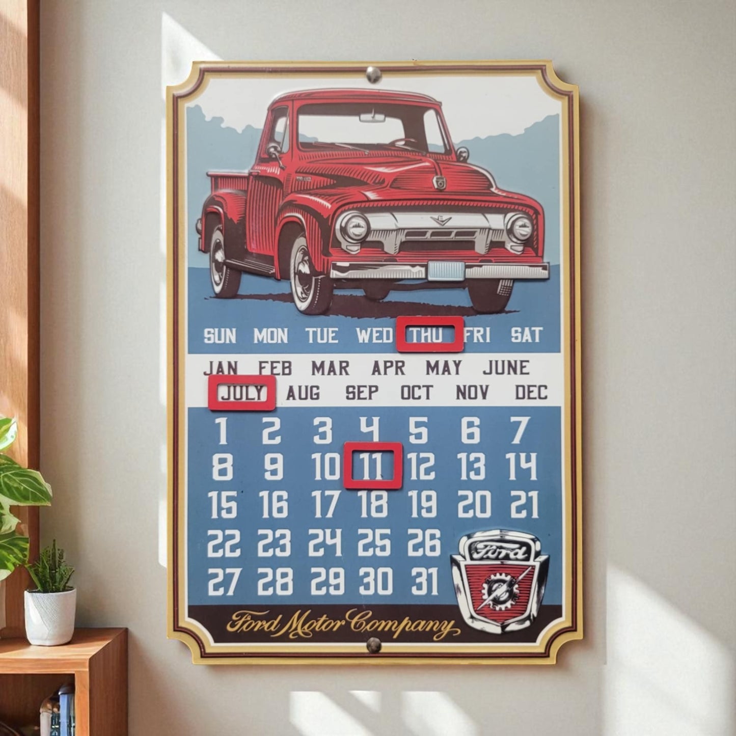Vintage-style calendar with a red truck design on a wall.