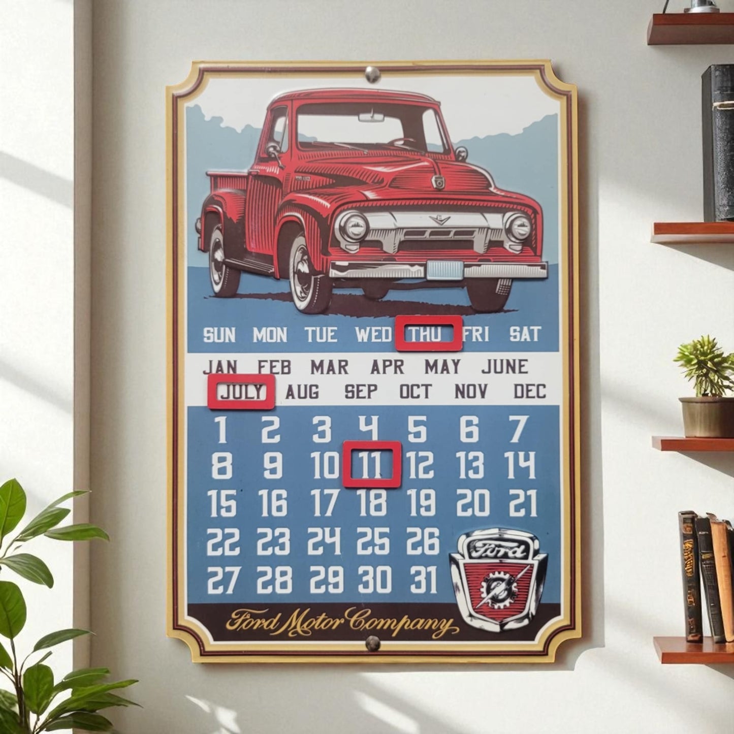 Framed calendar with a red vintage truck design on a white wall.