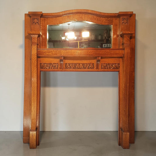 Historic Arts & Crafts oak fireplace mantle with original beveled mirror.