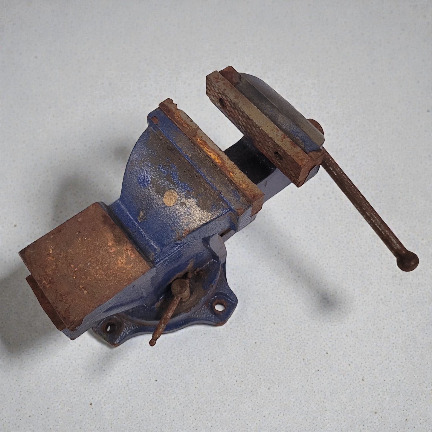 Rust-colored vise on a light gray background