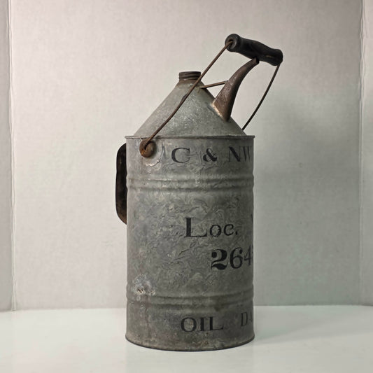 Antique galvanized oil can with classic railroad-inspired industrial character.