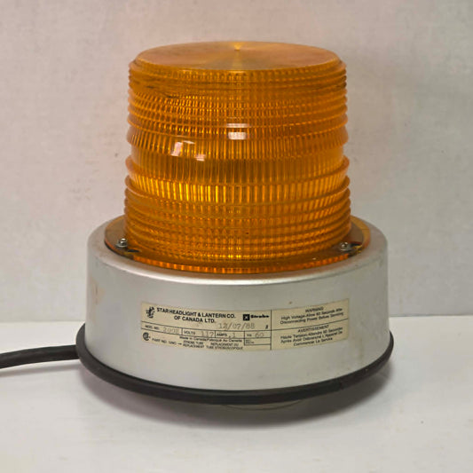 Vintage amber railroad strobe beacon light Star Headlight Model 200E industrial safety lamp with 360 degree flash and threaded base mount.
