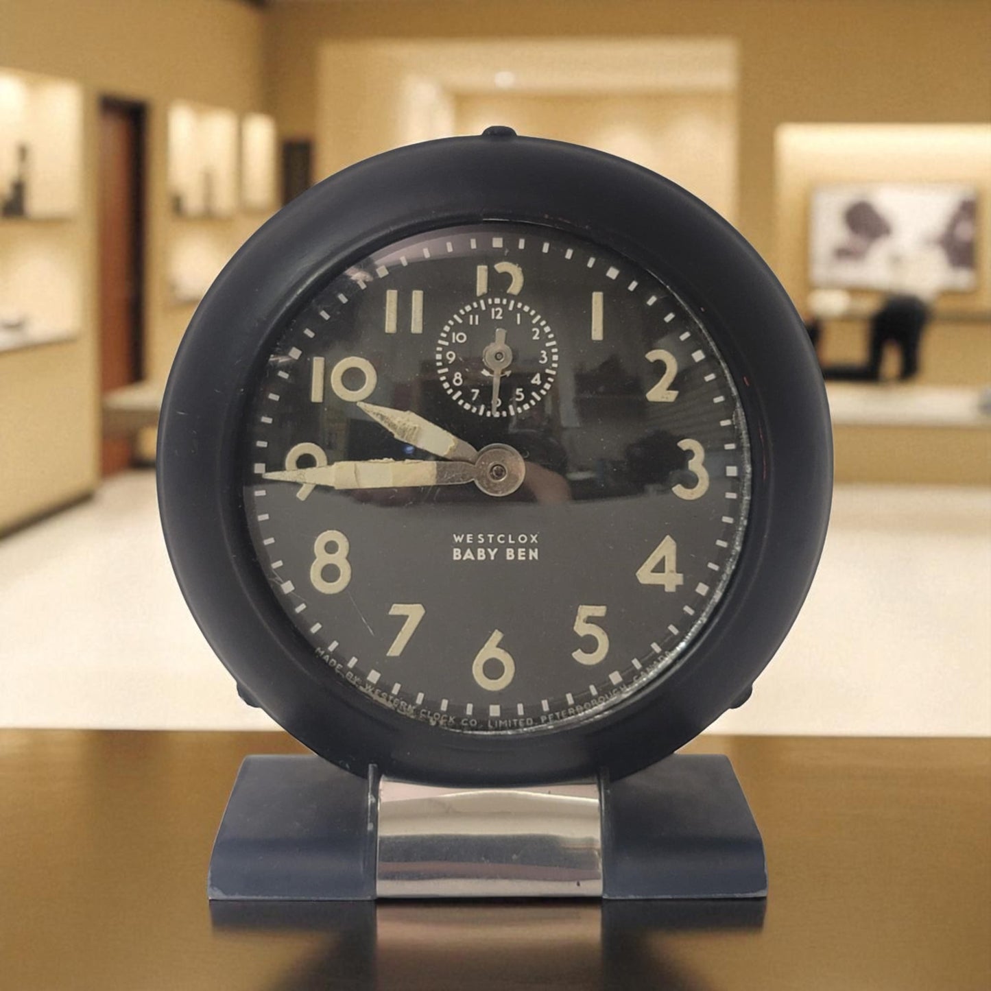 Black alarm clock with Westclox branding on a blurred indoor background