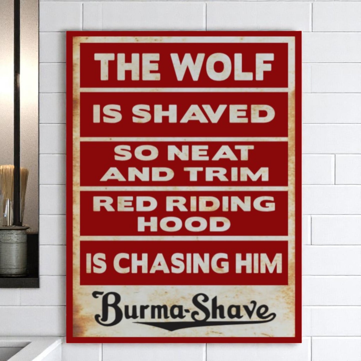 Vintage-style sign with text about 'The Wolf' and 'Red Riding Hood' on a white wall.