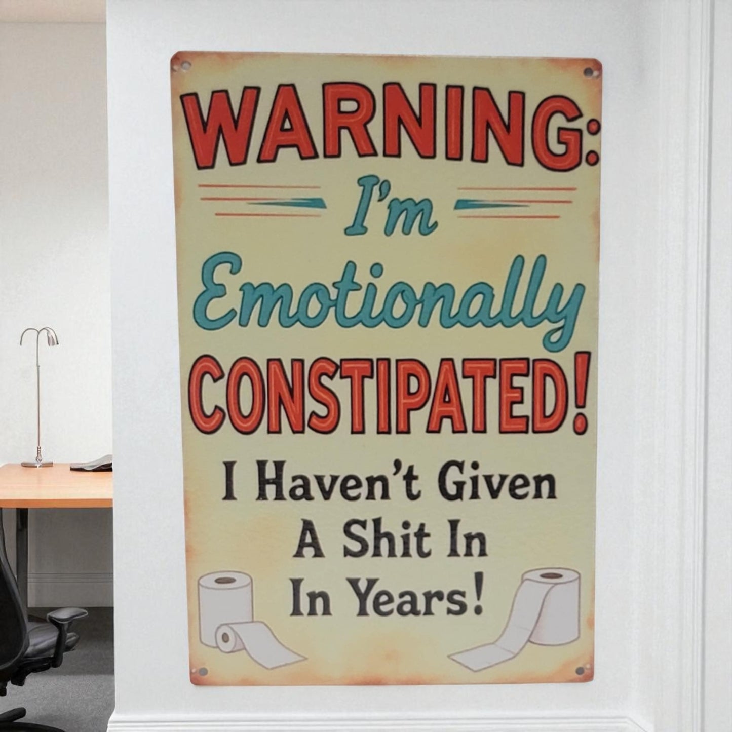 Humorous sign warning of emotional constipation in a room setting