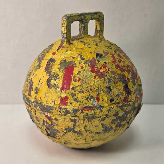 Antique yellow Newfoundland fishing buoy stamped Phillips Trawl Products Ltd., Grimsby England.