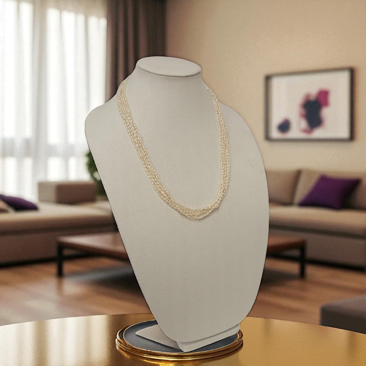 Pearl necklace on a mannequin bust in a living room setting