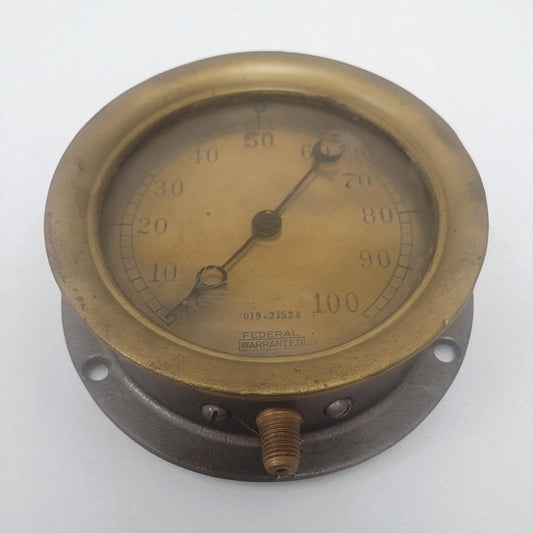 Vintage brass pressure gauge on a white background
