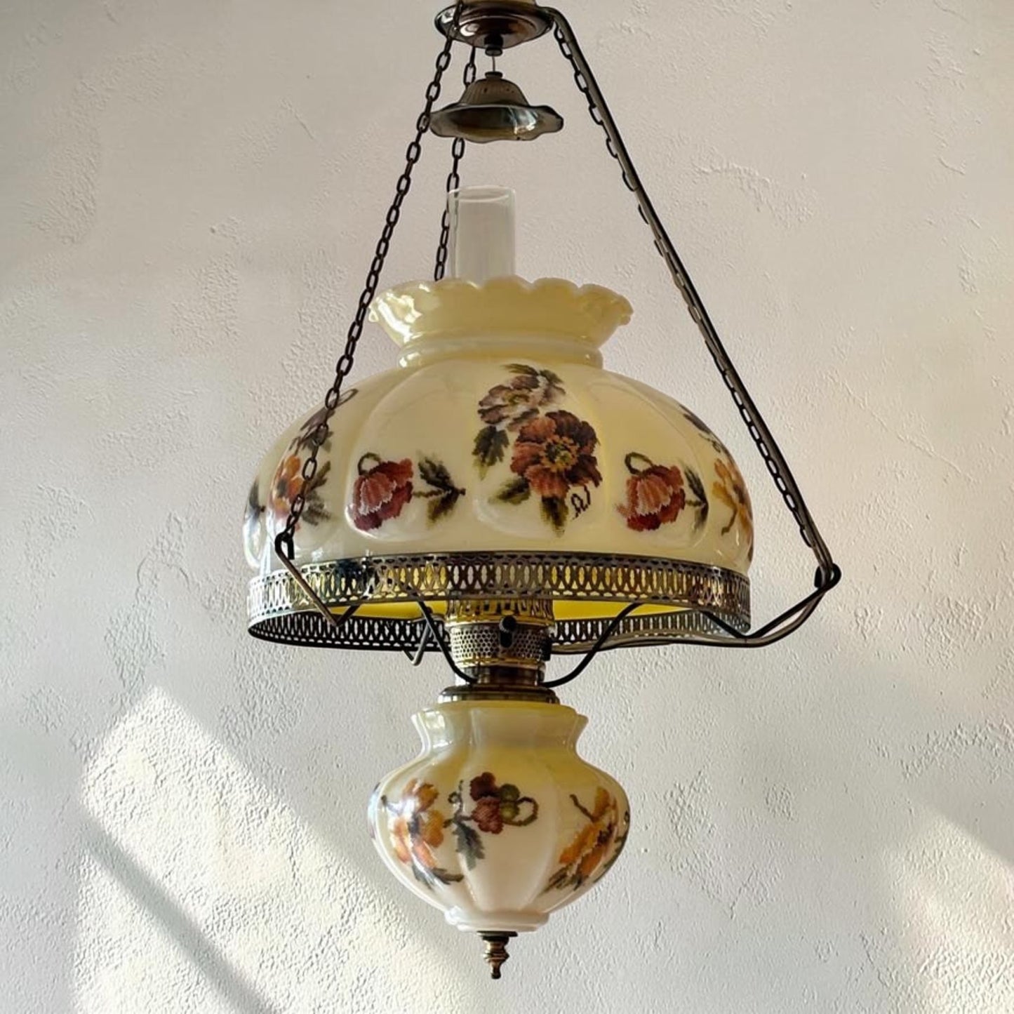 Large antique floral puffy hanging lamp with adjustable chain and 14-inch fitter.