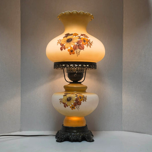 Vintage Gone with the Wind hurricane lamp with pastel yellow glass and cornflower floral decoration.