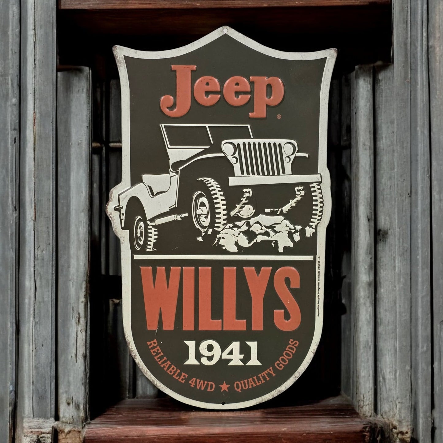 Decorative sign featuring Jeep Willys logo on a wooden background