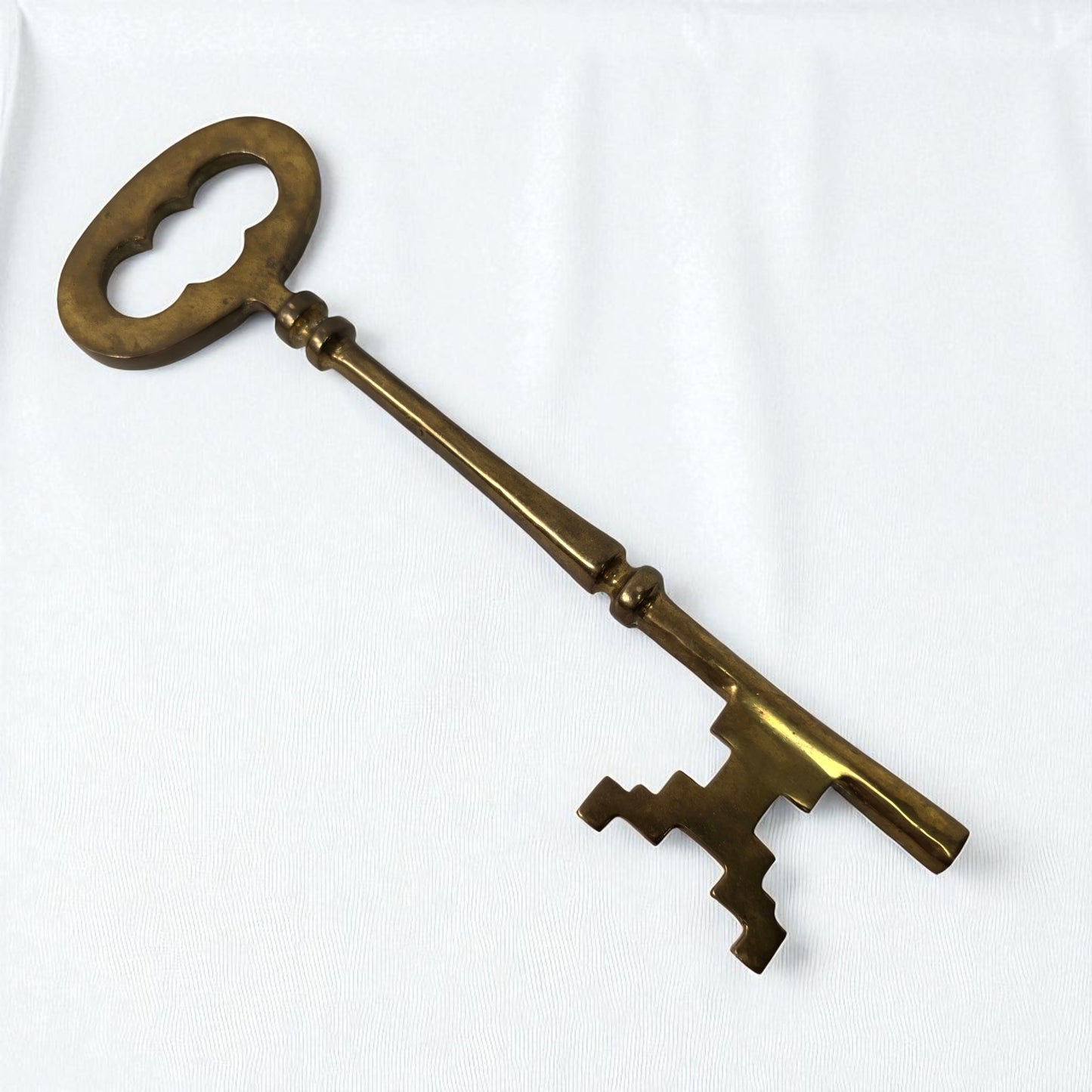 Vintage-style brass key on a white background