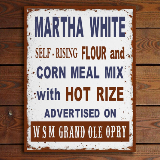 Vintage-style sign for Martha White flour and corn meal mix on a wooden background