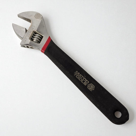 Adjustable wrench with black handle on a white background
