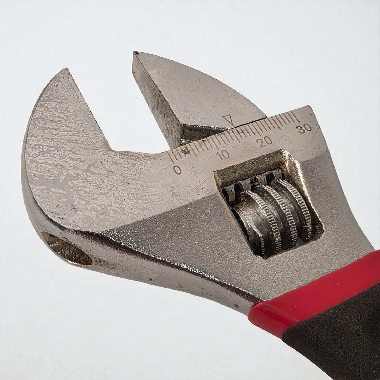 Adjustable wrench with measurement scale on a white background