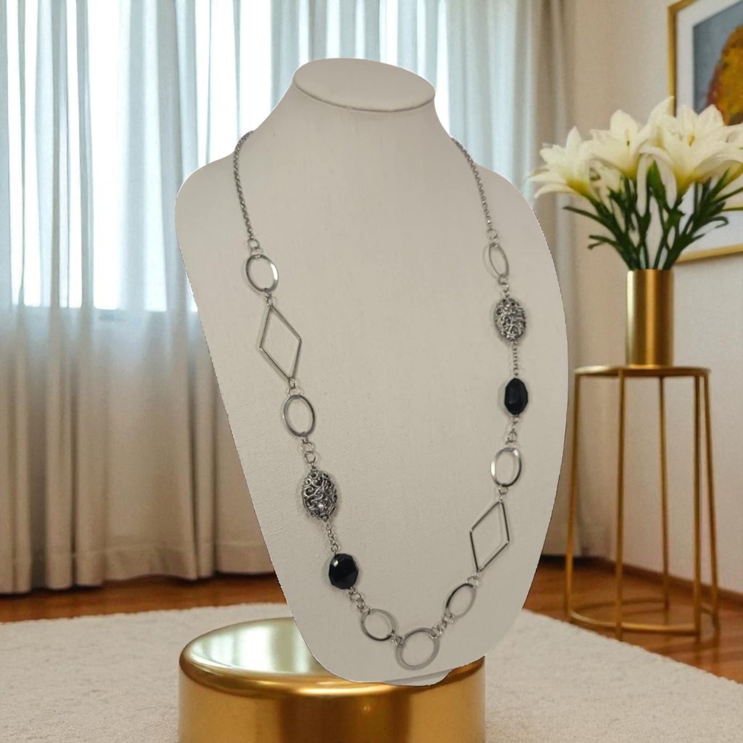 Necklace on a mannequin bust with a decorative background
