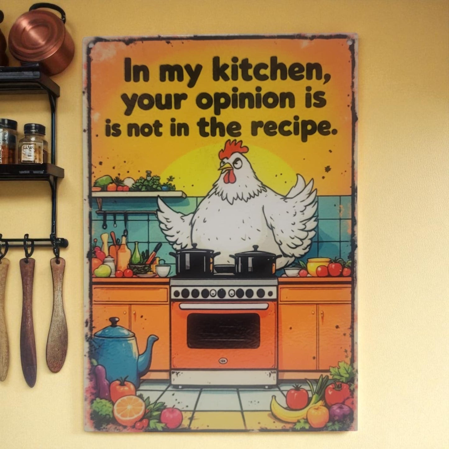 Decorative sign with a chicken in a kitchen and text on a yellow wall.