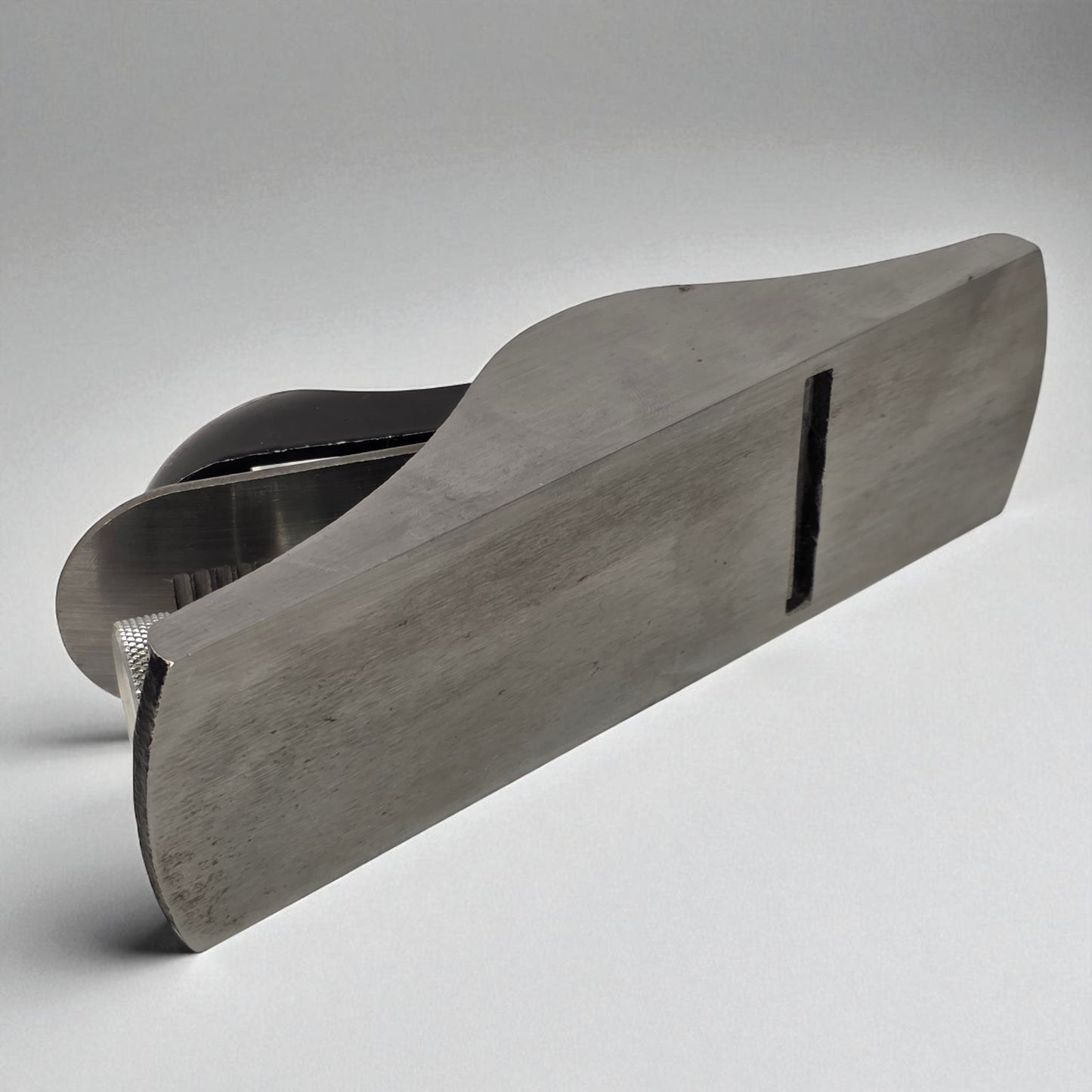 Metallic object with a textured surface on a gray background