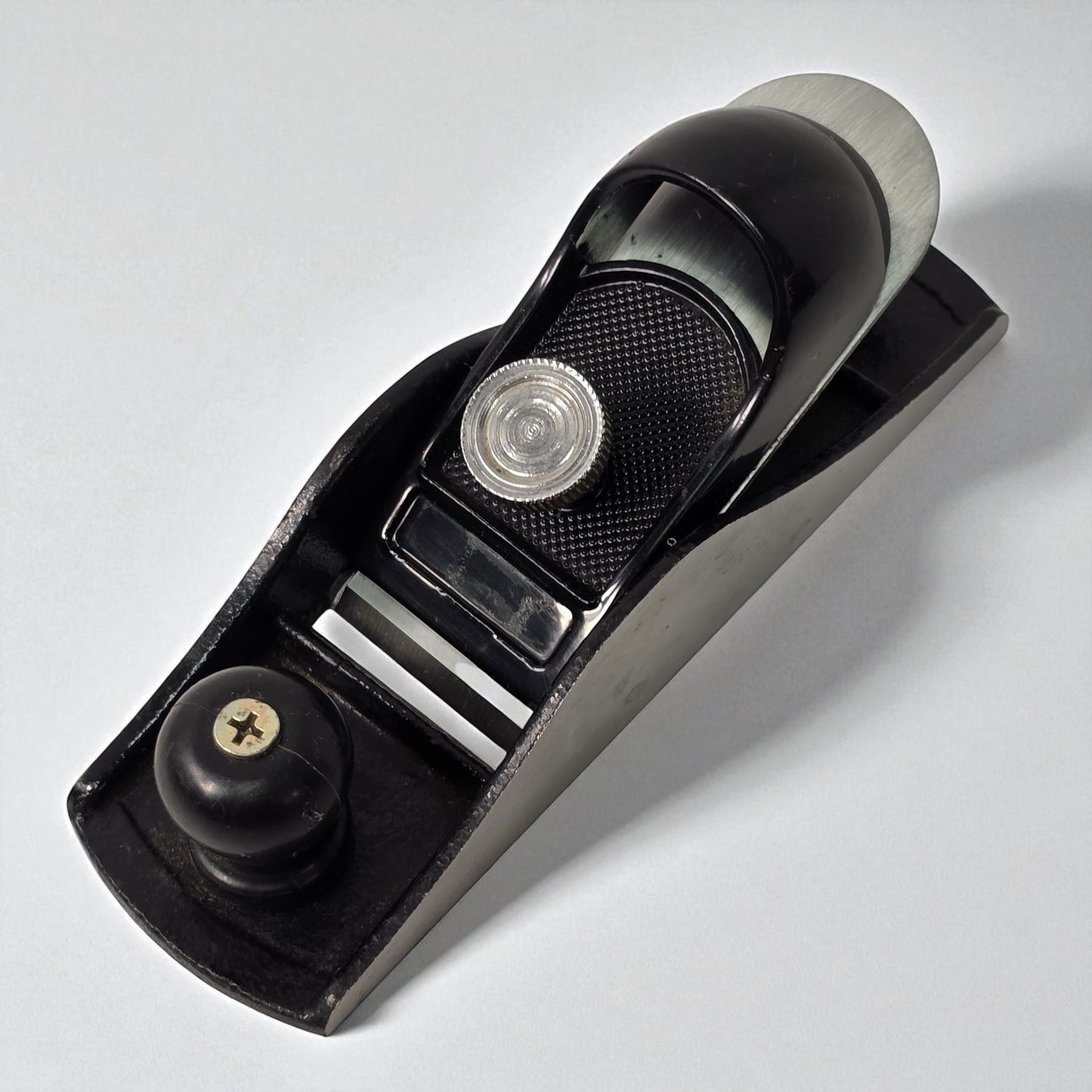 Black hand plane tool on a white background