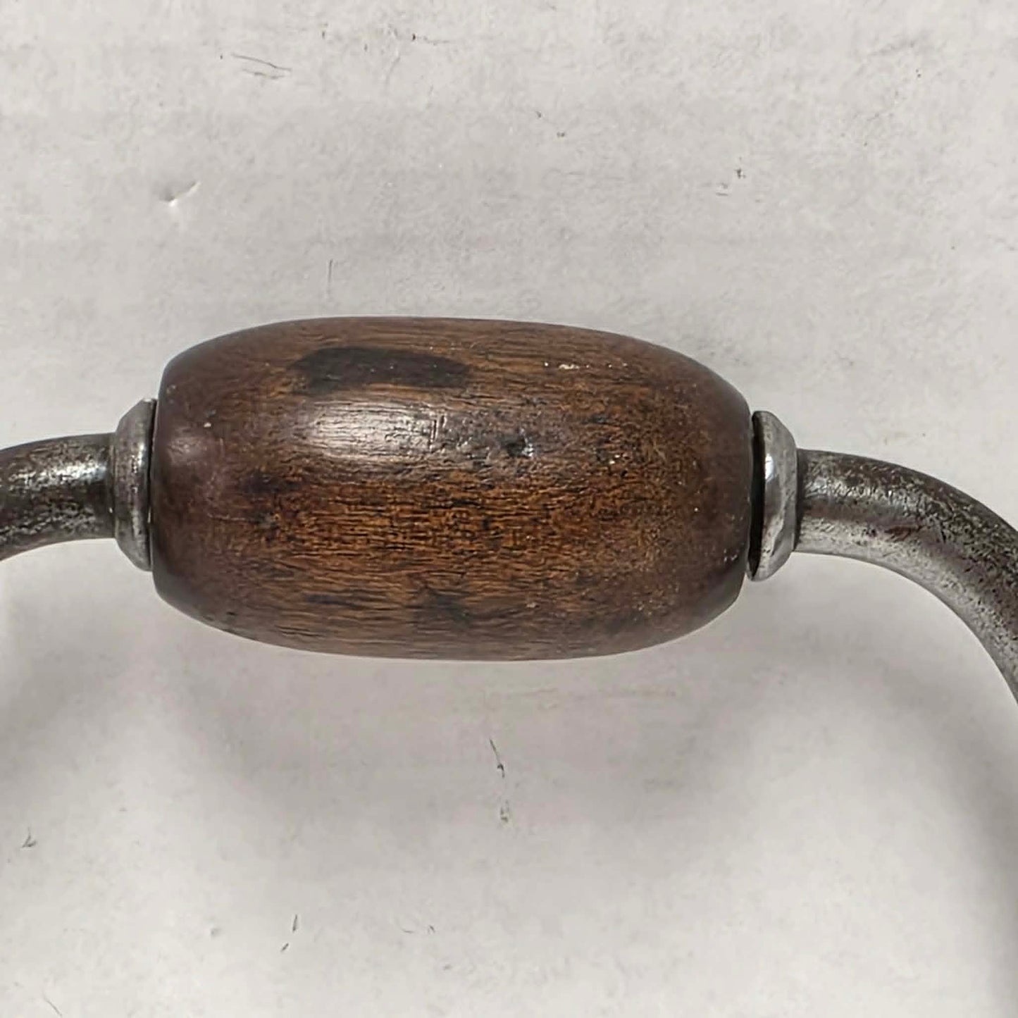 Antique primitive carpenter's bit brace with wood and brass handle.