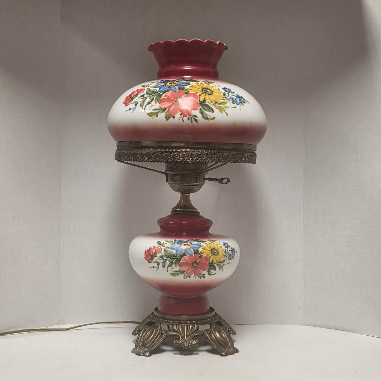 Vintage Gone with the Wind hurricane lamp with red and white floral glass and tri-light feature.
