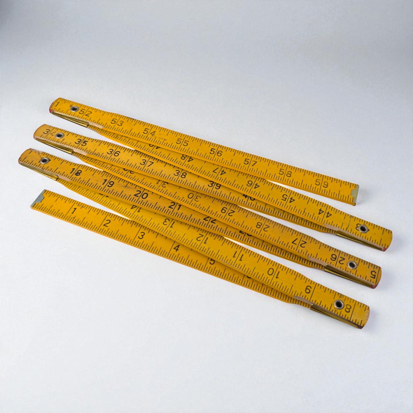 Set of yellow wooden rulers on a white background
