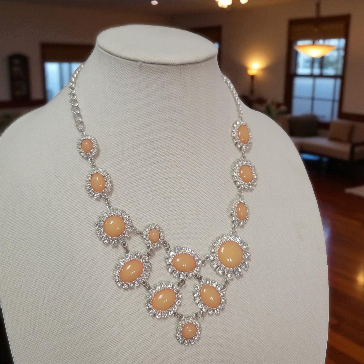 Necklace with peach-colored stones on a mannequin in a room setting