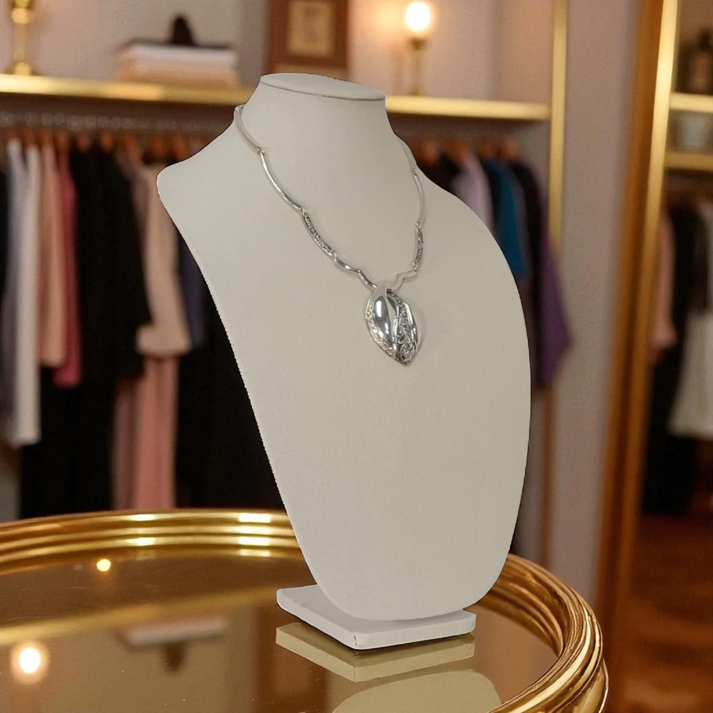 Necklace on a mannequin bust in a clothing store setting