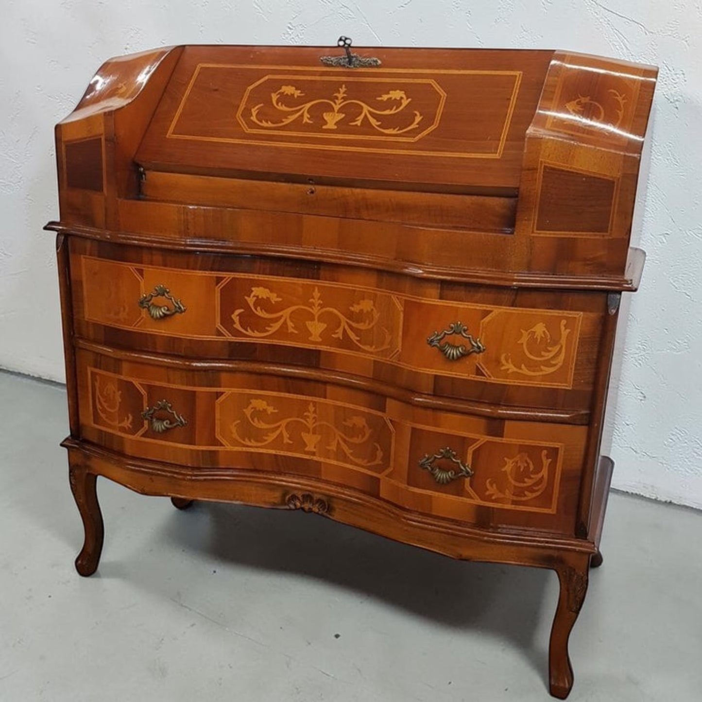 Louis XVI-style inlaid marquetry writing desk with walnut and fruitwood, featuring drop-down surface and interior drawers.