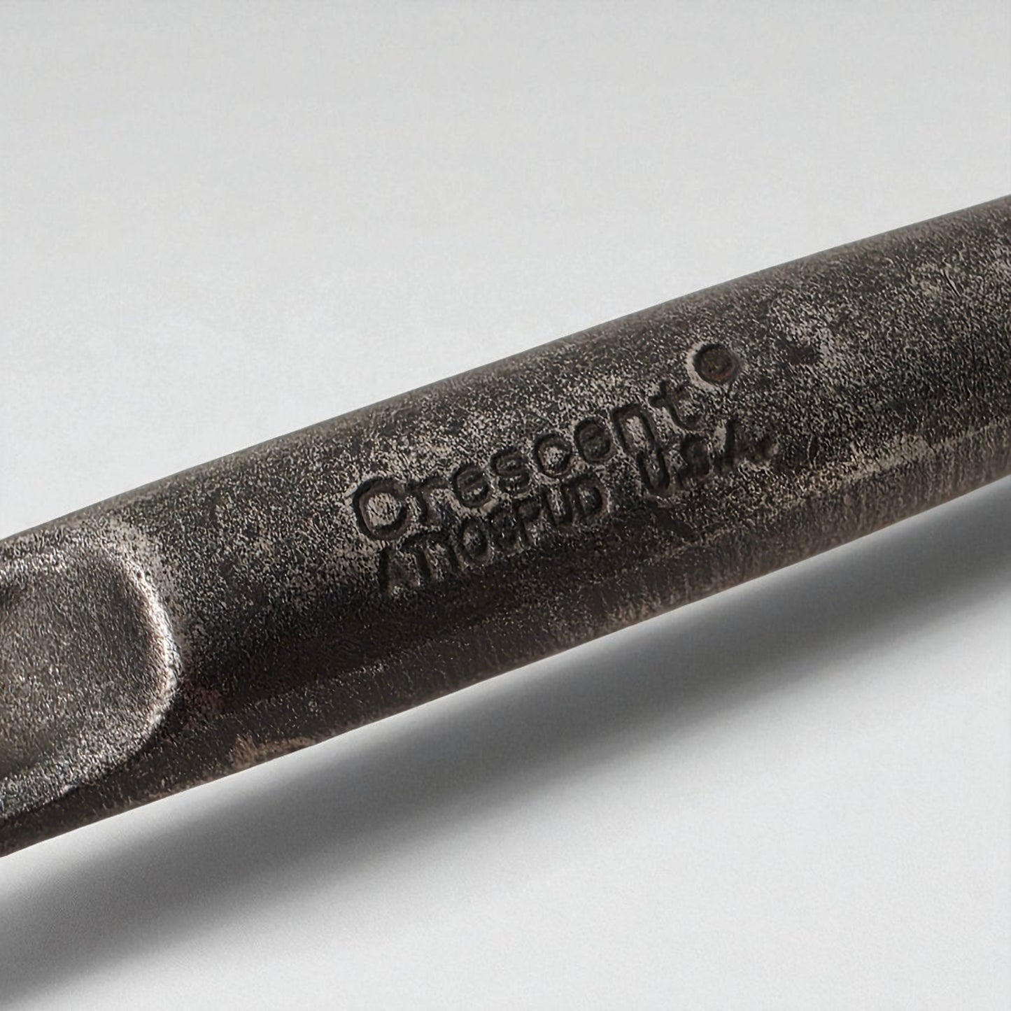 Close-up of a tool with cresent branding on a light gray background