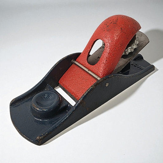 Vintage hand plane with red leather handle on a white background