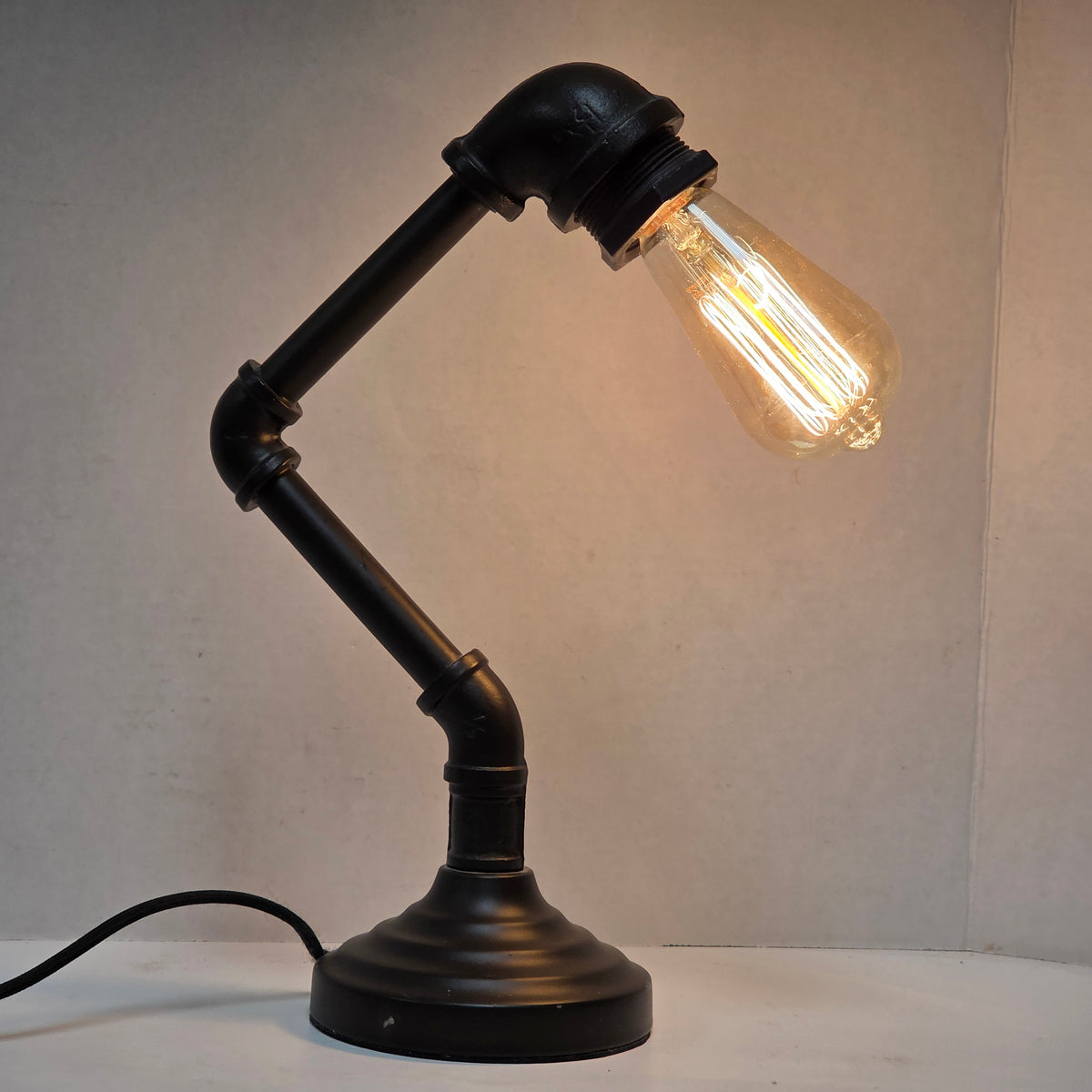 Industrial plumbing pipe lamp with vintage Edison bulb