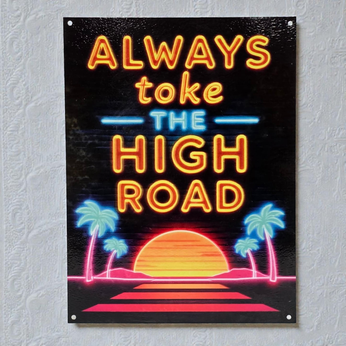 Neon-style sign with 'Always toke the high road' text on a black background with palm trees and sunset.