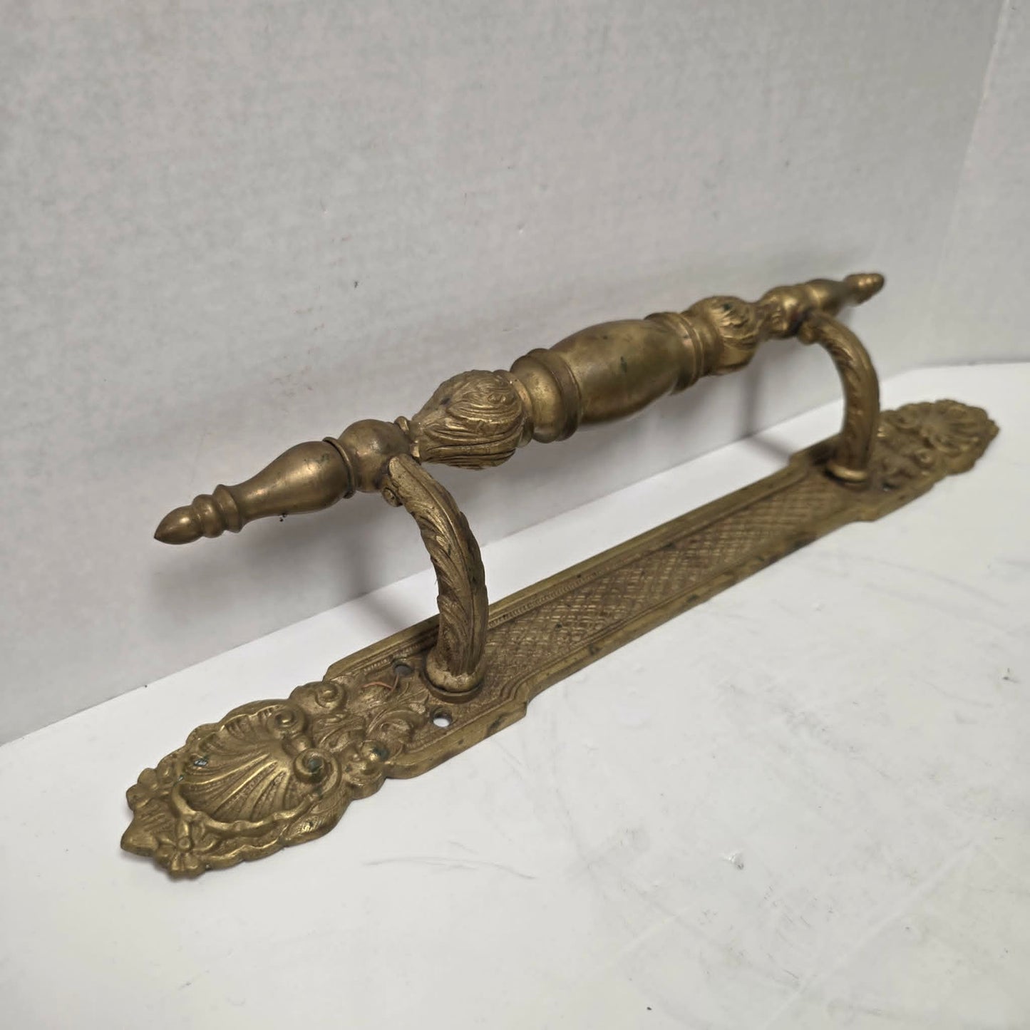 Pair of large Victorian brass bronze hotel door handles with butterfly design, crosshatched plates, and shell details. Antique architectural salvage hardware.