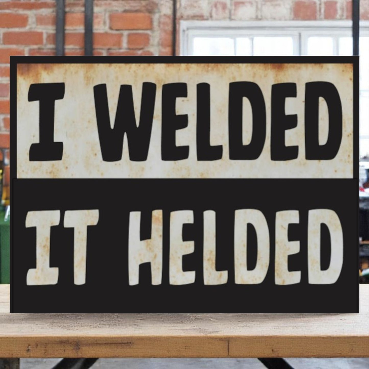Garage wall art featuring the phrase 'I welded, it helded' on an aluminum sign