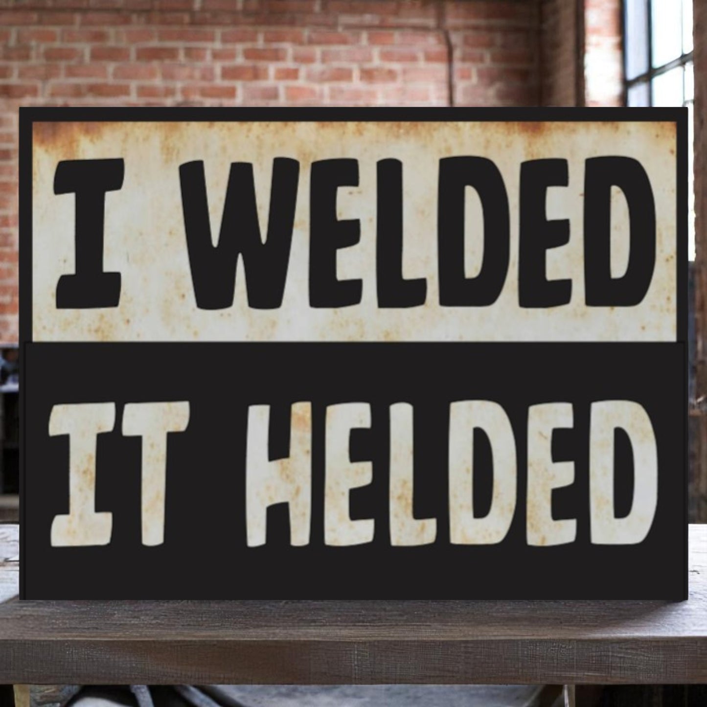 Garage wall art featuring the phrase 'I welded, it helded' on an aluminum sign
