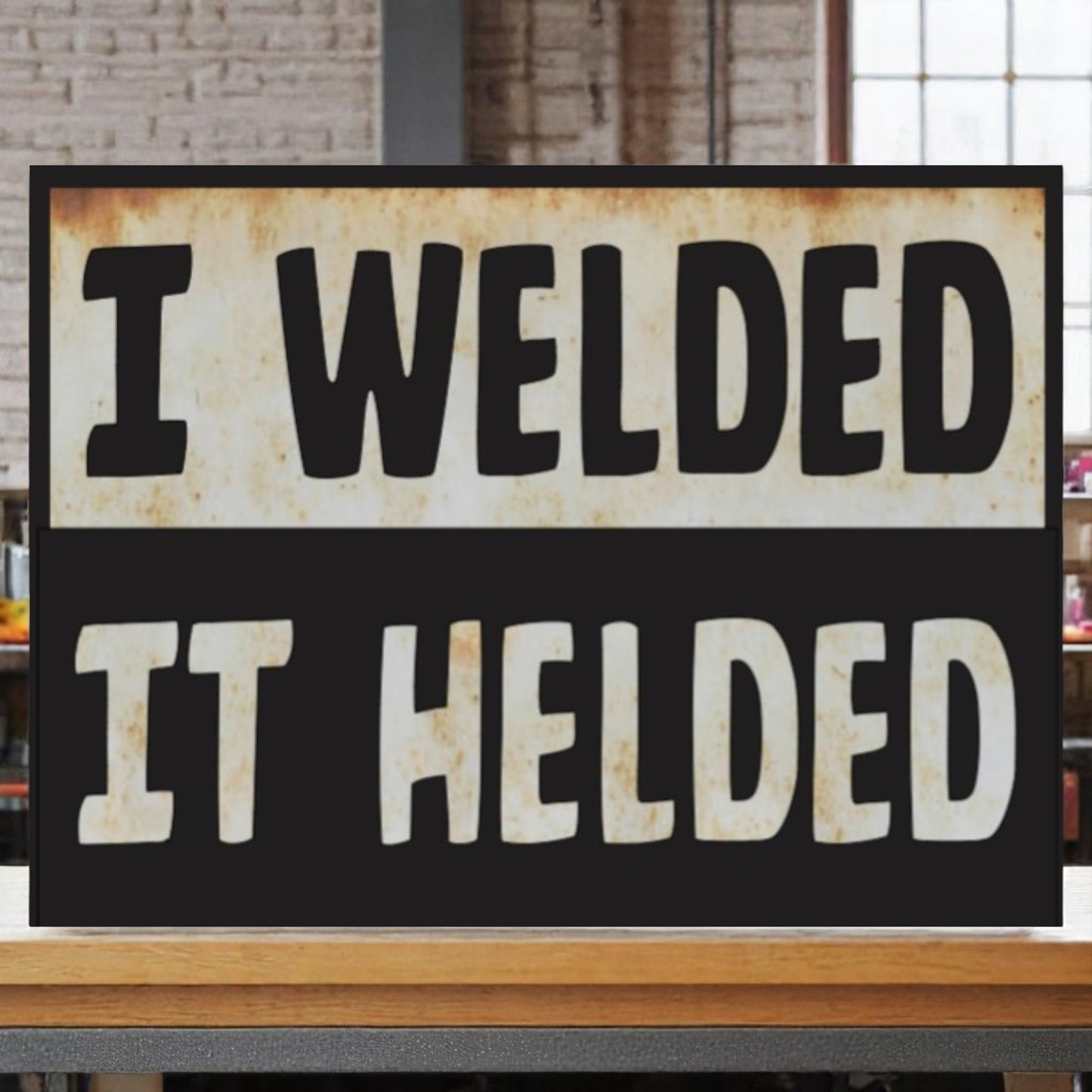 Garage wall art featuring the phrase 'I welded, it helded' on an aluminum sign